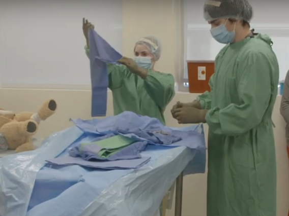 Three veterinary students participate in a surgery and anesthesia simulation.
