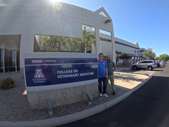 Two members of our financial aid team pose next to a College of Veterinary Medicine sign.