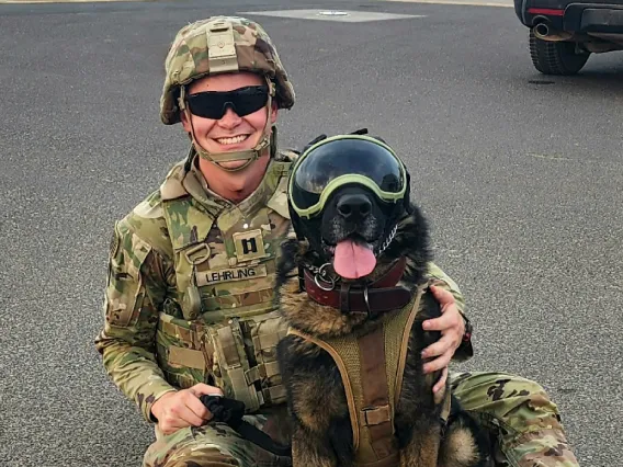 Photo of Luke Lehrling with a German Shepherd dog.