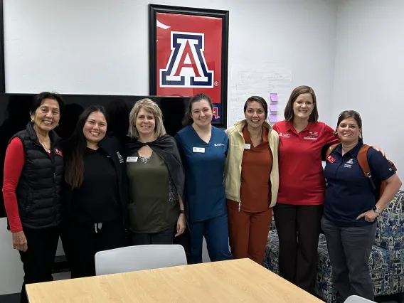 A group of seven College of Veterinary Medicine faculty and staff members pose together and smile.