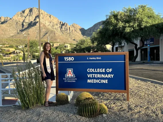 Abigail Berry by the College of Veterinary Medicine sign