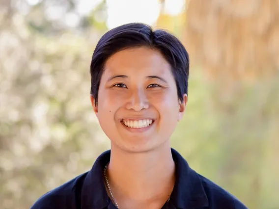 Person with short hair, wearing a dark blue polo.