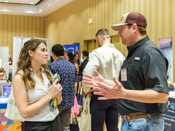 Student talking with practice owner at the career fair. 