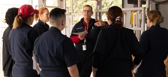Instructor speaking to group of students