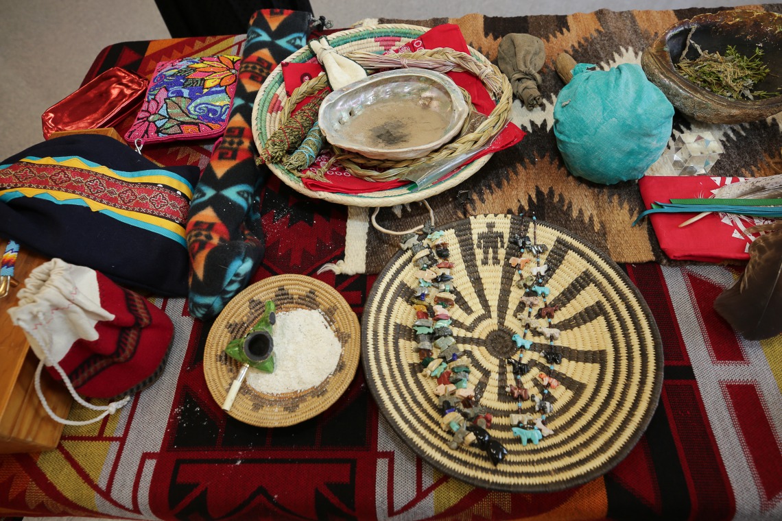 A table is covered with artifacts for a Native American blessing ceremony.