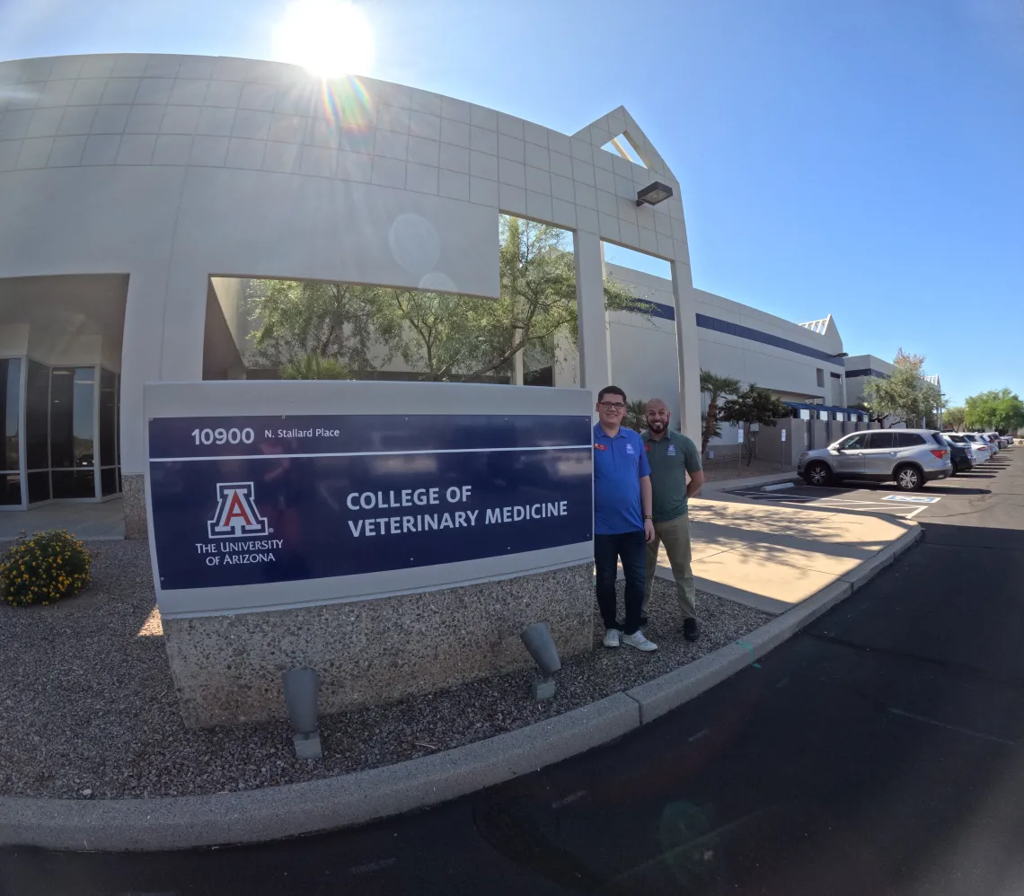 Two members of our financial aid team pose next to a College of Veterinary Medicine sign.