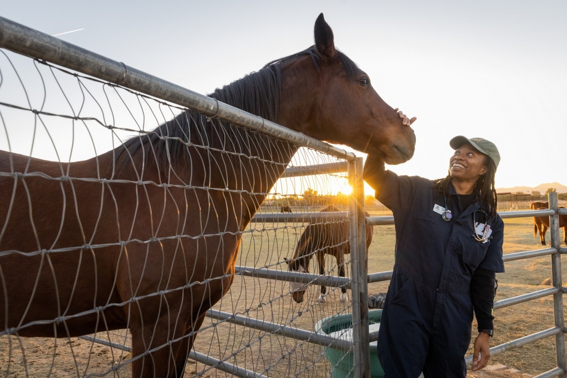 Dominique Williams with a horse at the Campus Agricultural Center