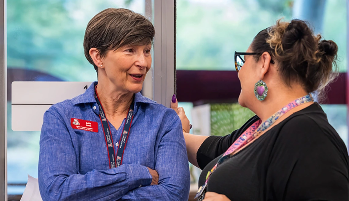 Two faculty members talking to each other