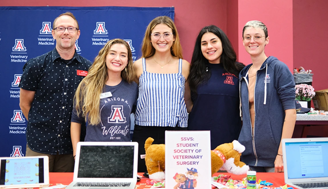 Group of students standing at table during club fair