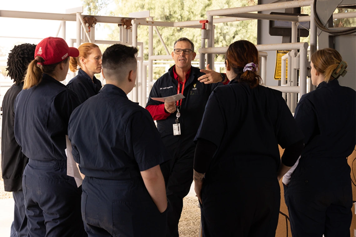 Instructor speaking to group of students