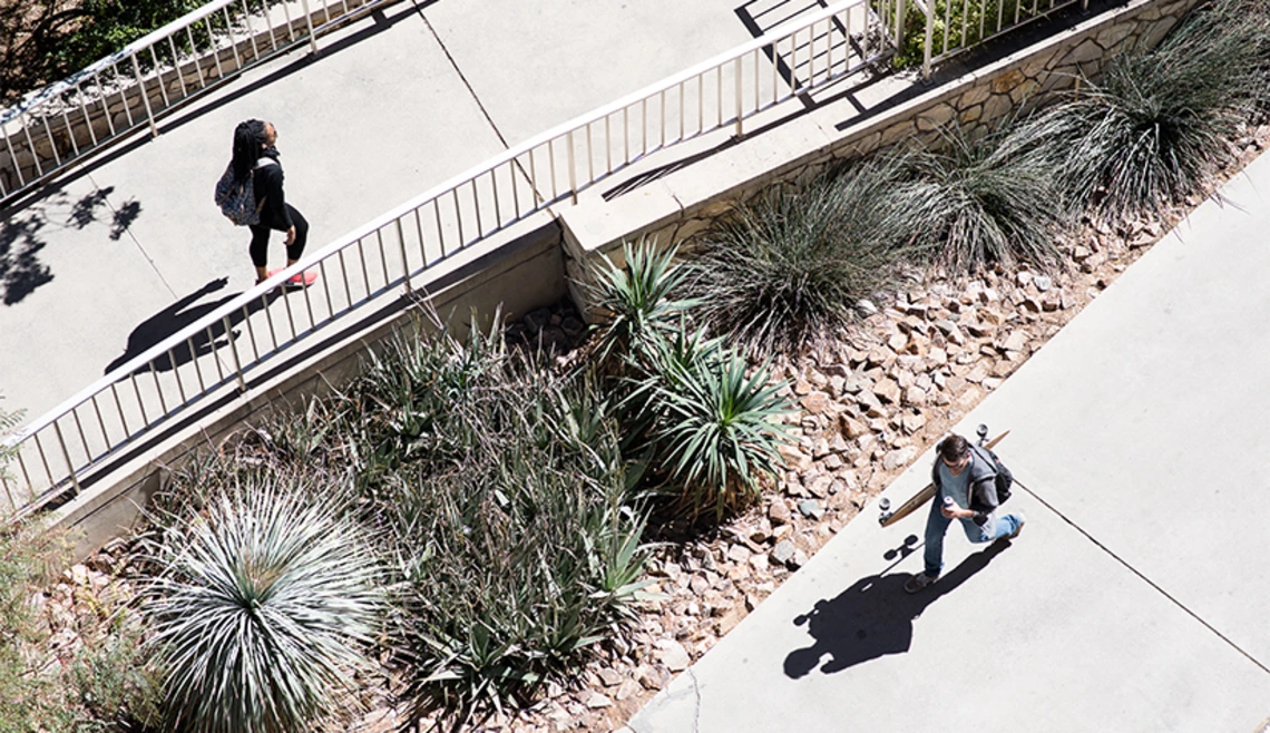 Aerial shot of students walking on UA campus sidewalks