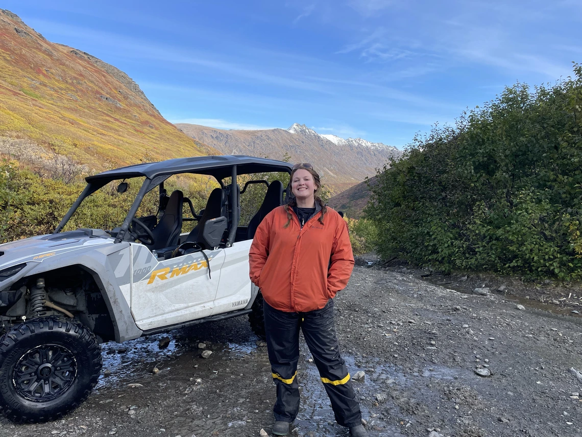 Riley posing with a off-road vehicle