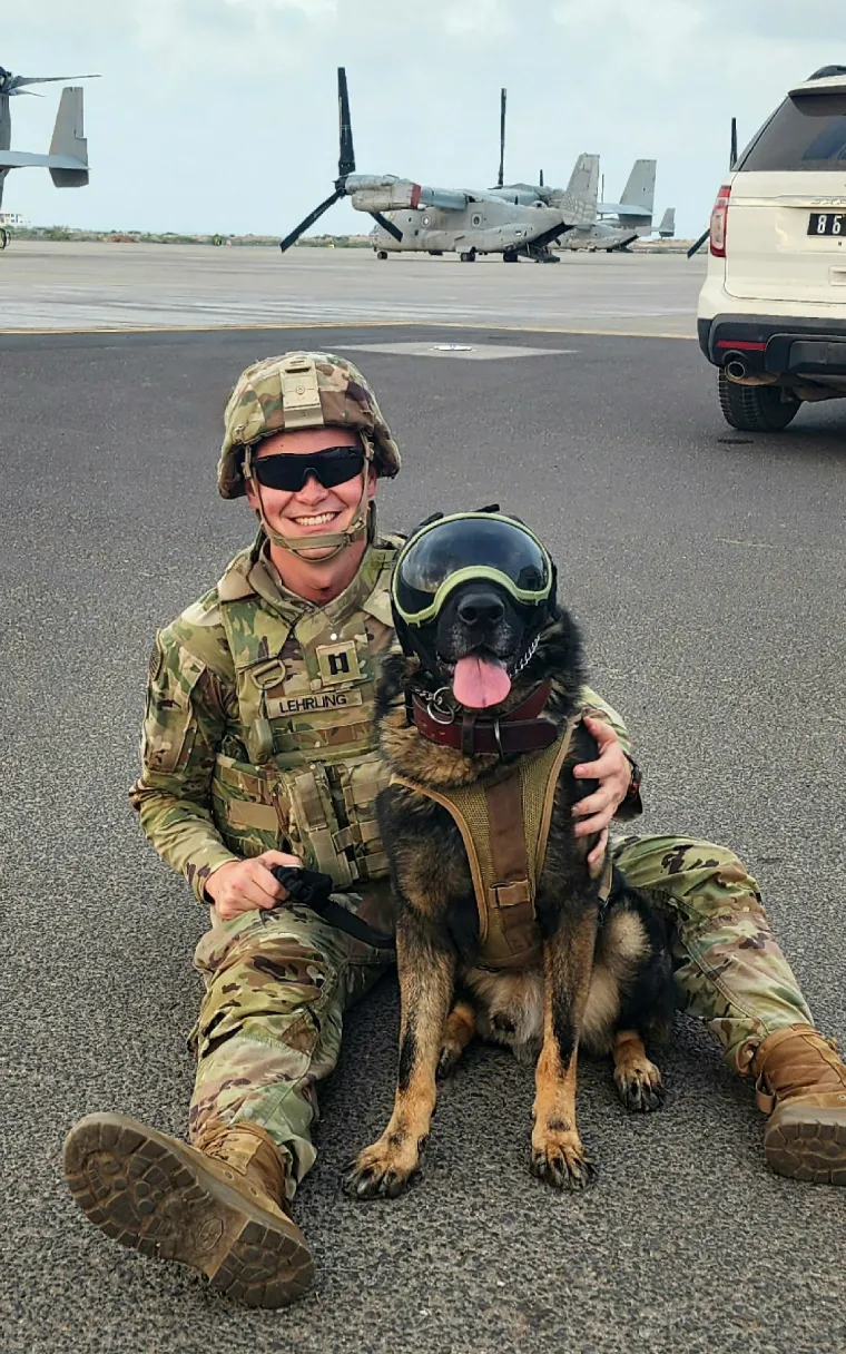 Photo of Luke Lehrling with a German Shepherd dog.