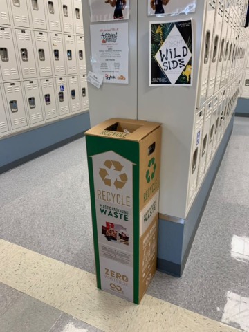 A recycling box near lockers in a student area.