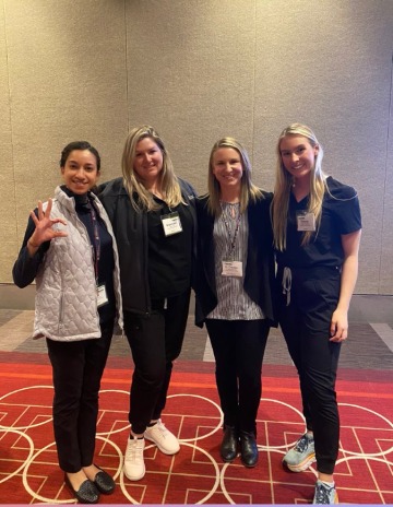 Four veterinary students stand together at SAVMA Symposium.