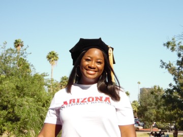 Ari Adams smiles in an Arizona t-shirt and her graduation cap.