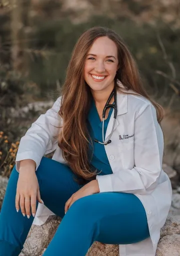 Morgan Beckham wears her white doctor coat and smiles.