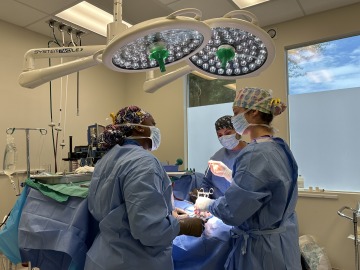 Arianna Adams wears scrubs and participates in surgery at VetMED.