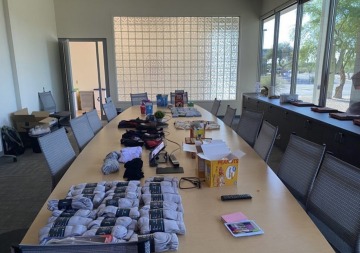 Conference table covered with new socks and healthy snack foods.