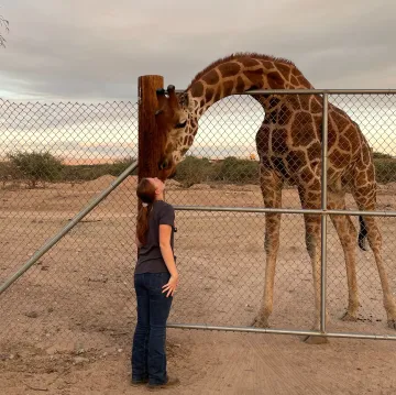 Abigail Berry with a giraffe during her clinical year