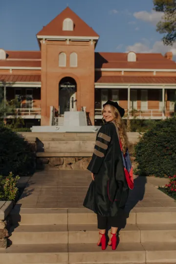 Cierra Smith in regalia in front of old main