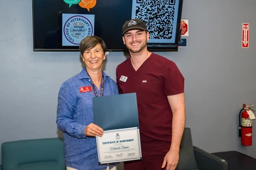 Dean Funk gives out certificates to participates of the summer research series.