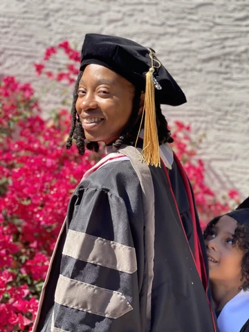 Domo williams with graduation regalia