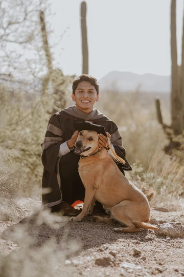 brendan walker with his dog celebrating graduation