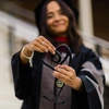 Alia holding her stethoscope as a heart