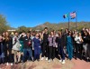 A group of around 55 veterinary students pose together outside the Arizona-Sonoran Desert Museum.