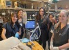 Veterinary students surround a table, where an animal is undergoing mechanical ventilation.